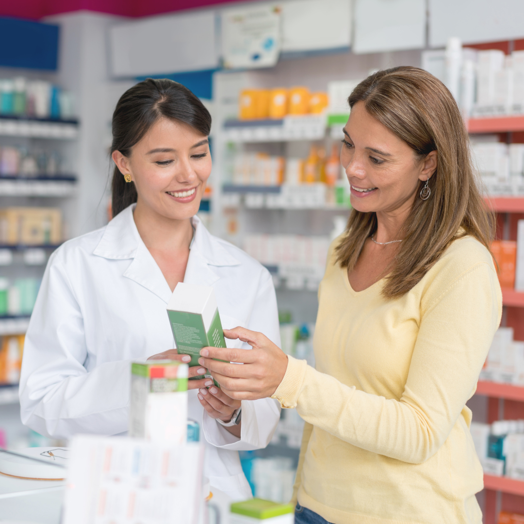 A pharmacist advising a customer at the counter