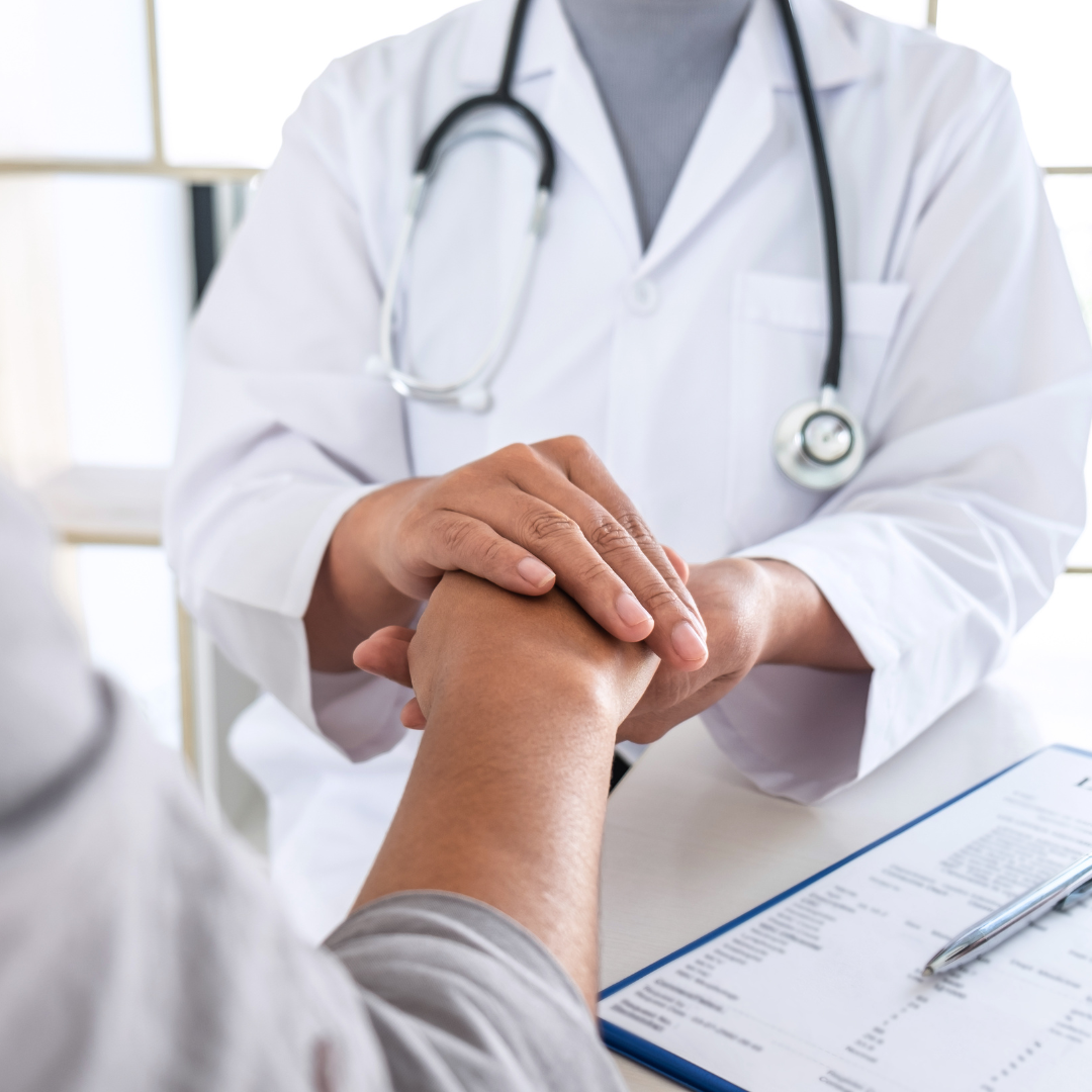 A doctor reassuring a patient during a consultation